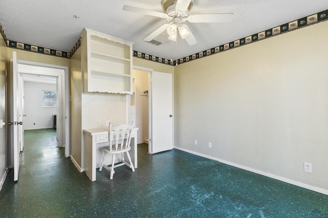 interior space featuring ceiling fan and a textured ceiling