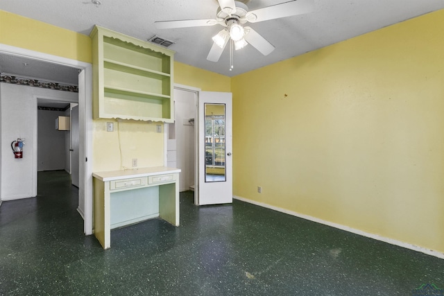 interior space featuring a textured ceiling and ceiling fan