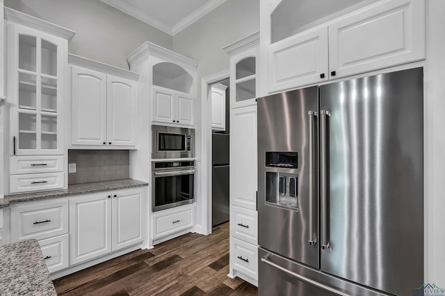 kitchen with glass insert cabinets, ornamental molding, white cabinetry, and appliances with stainless steel finishes