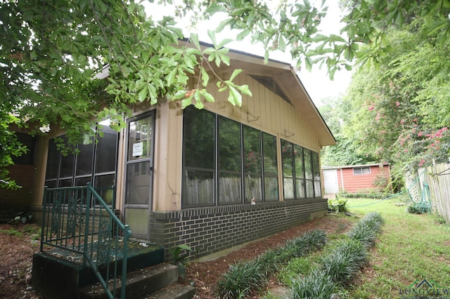 view of property exterior with a sunroom