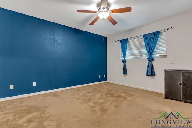 empty room with carpet flooring and ceiling fan