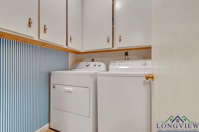 laundry area featuring cabinets and separate washer and dryer