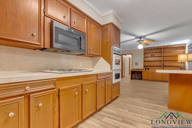 kitchen featuring ceiling fan, light hardwood / wood-style floors, white appliances, and ornamental molding