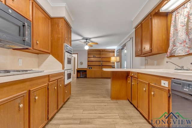 kitchen with light hardwood / wood-style floors, crown molding, white appliances, and sink