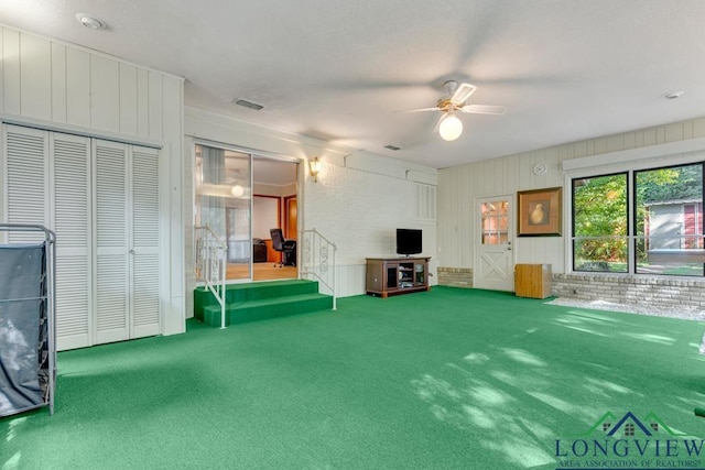 interior space with ceiling fan and carpet floors