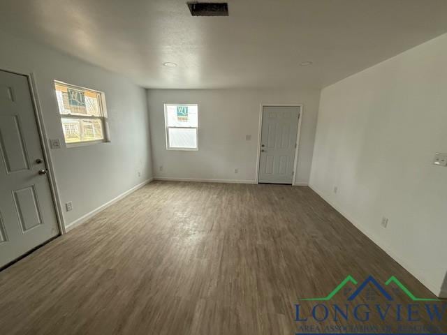 interior space featuring baseboards and wood finished floors