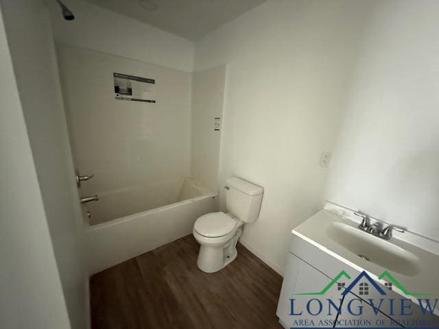 full bath with toilet, shower / bathtub combination, wood finished floors, and vanity