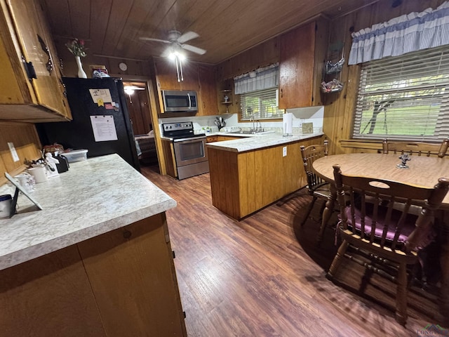 1641 Handy Rd, Diana, TX 75640 - kitchen featuring stainless steel appliances, a peninsula, light countertops, dark wood finished floors, and wood ceiling