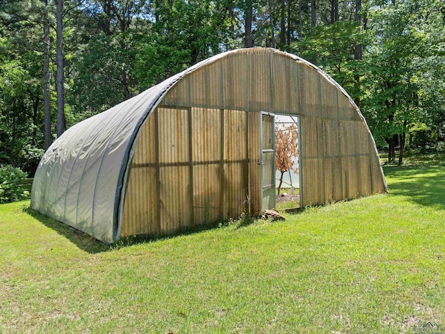 view of outbuilding featuring a yard