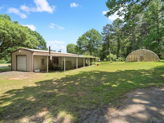 view of yard with a garage and an outdoor structure