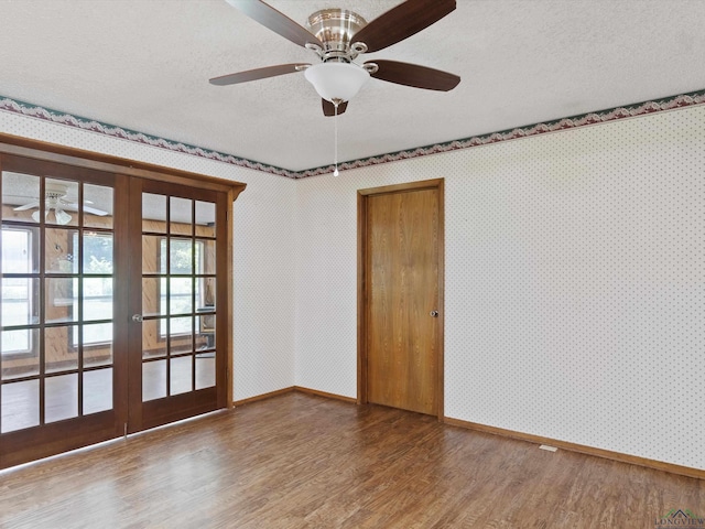 spare room with ceiling fan, french doors, a textured ceiling, and hardwood / wood-style flooring