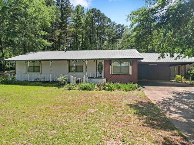 ranch-style house featuring a carport and a front lawn