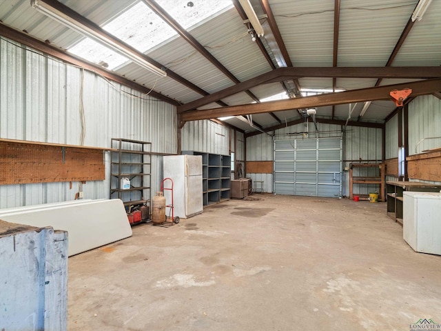 garage with a garage door opener and white refrigerator