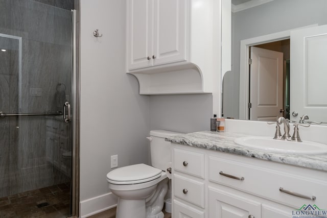 bathroom featuring vanity, toilet, an enclosed shower, and crown molding