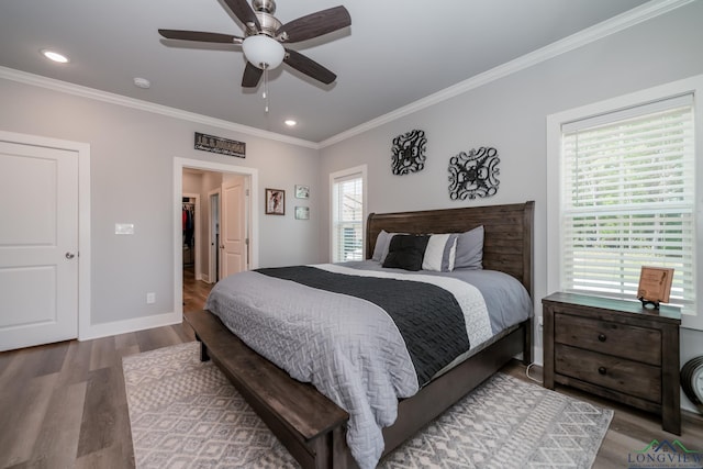 bedroom featuring hardwood / wood-style flooring, ceiling fan, and crown molding