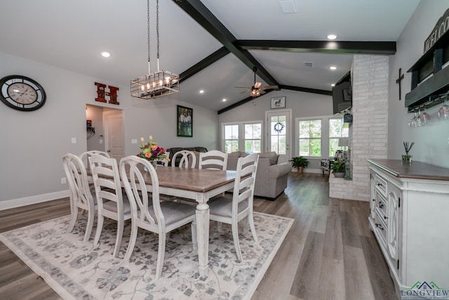 dining room with ceiling fan, lofted ceiling with beams, and hardwood / wood-style flooring