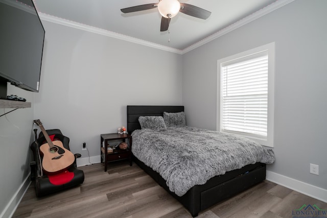 bedroom featuring wood-type flooring, ceiling fan, and crown molding