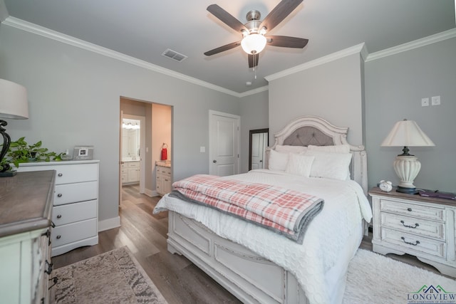 bedroom with hardwood / wood-style flooring, ceiling fan, ornamental molding, and ensuite bath