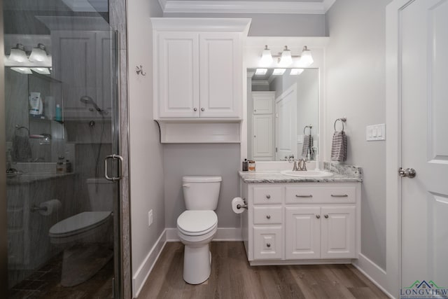 bathroom featuring walk in shower, wood-type flooring, toilet, vanity, and ornamental molding