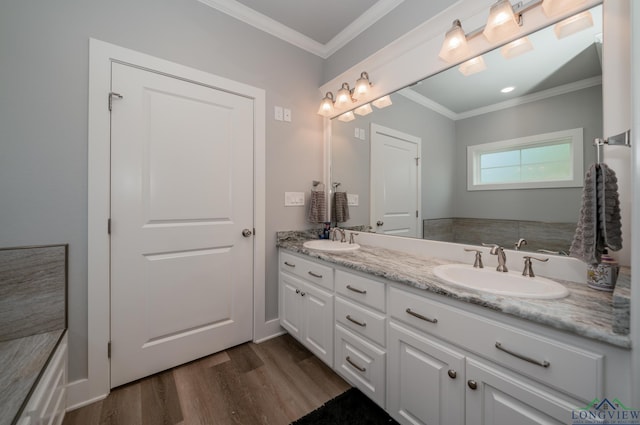 bathroom featuring hardwood / wood-style flooring, vanity, and ornamental molding