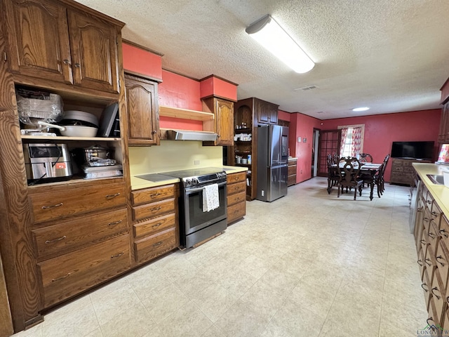 kitchen with stainless steel appliances and a textured ceiling