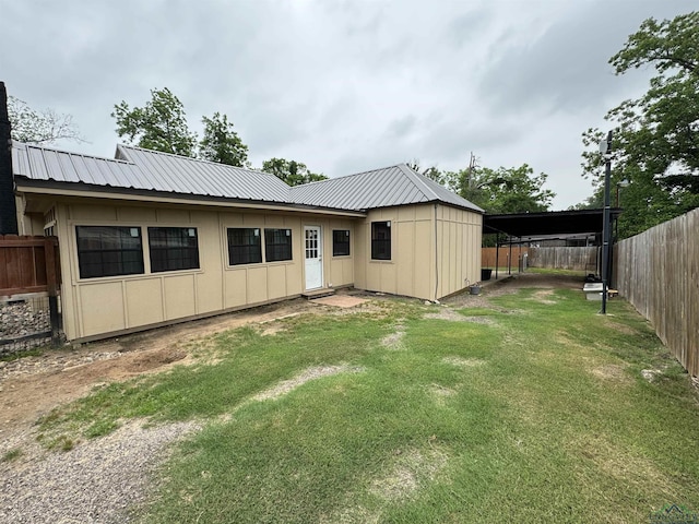 rear view of property with a lawn