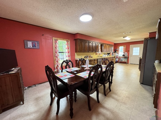 dining space featuring a textured ceiling