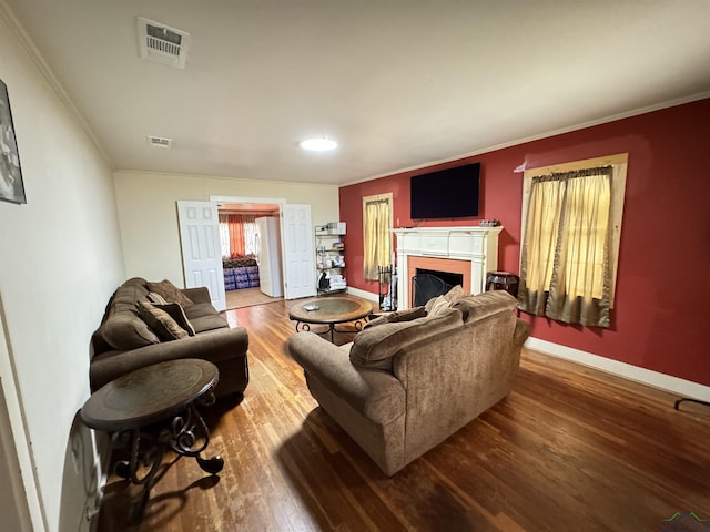 living room with hardwood / wood-style floors and ornamental molding