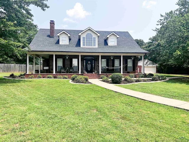 view of front of house featuring fence, a front lawn, a porch, and brick siding