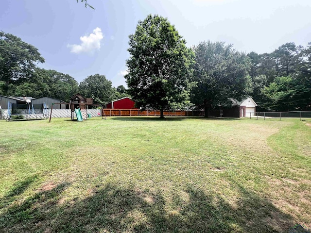 view of yard featuring a fenced backyard and a playground