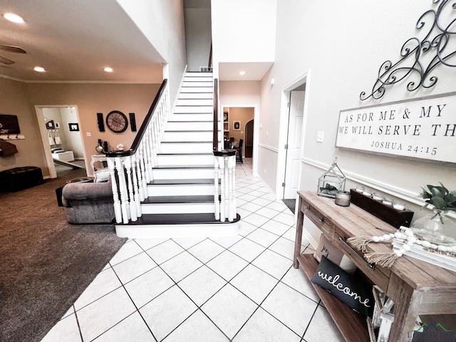 stairway featuring tile patterned floors, carpet flooring, and recessed lighting