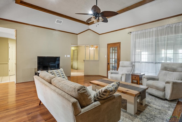 living area featuring visible vents, a ceiling fan, wood finished floors, and crown molding