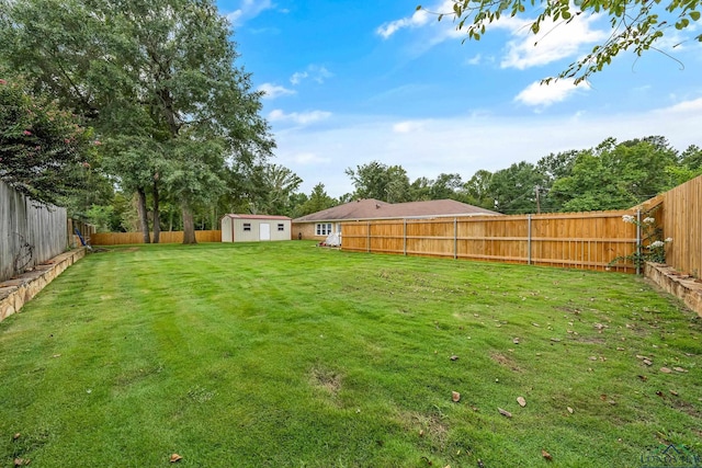 view of yard with a fenced backyard, a storage unit, and an outdoor structure