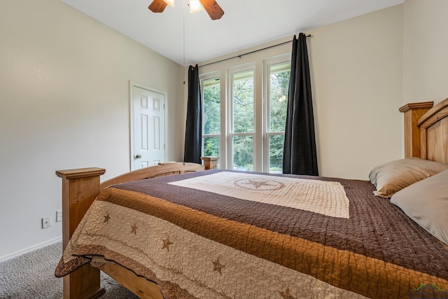 carpeted bedroom featuring a ceiling fan and baseboards