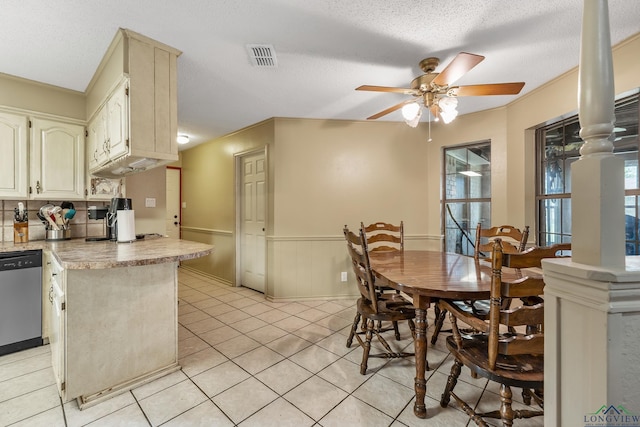 dining room with light tile patterned floors, visible vents, ornate columns, and a textured ceiling