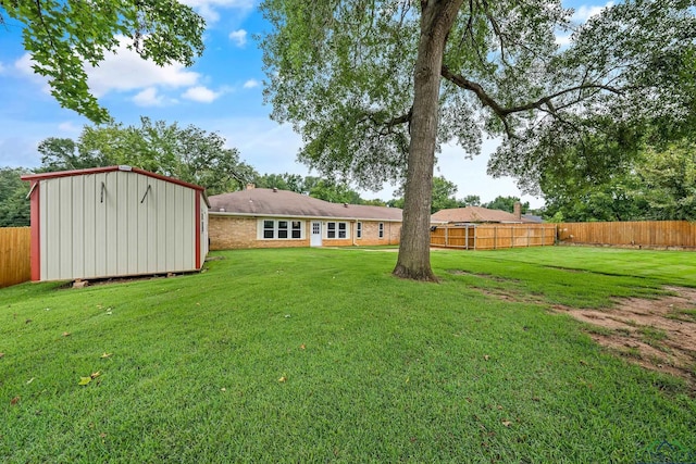 view of yard with a shed, fence private yard, and an outdoor structure