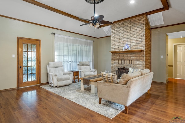 living area featuring a fireplace, crown molding, wood finished floors, and baseboards