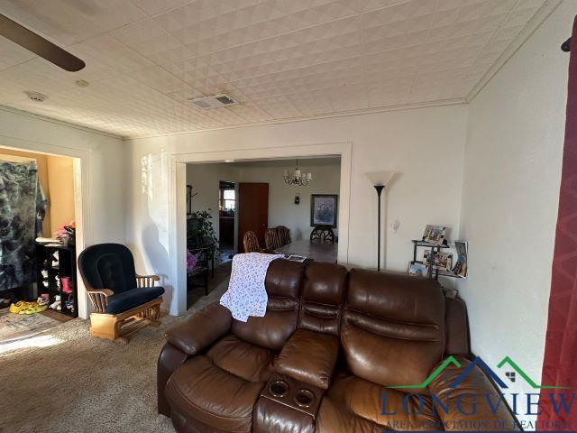 729 Rosehill Rd, Timpson, TX 75975 - living room with a chandelier, carpet, and ornamental molding