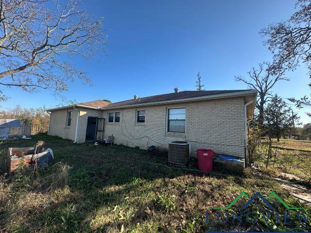 729 Rosehill Rd, Timpson, TX 75975 - back of house featuring brick siding