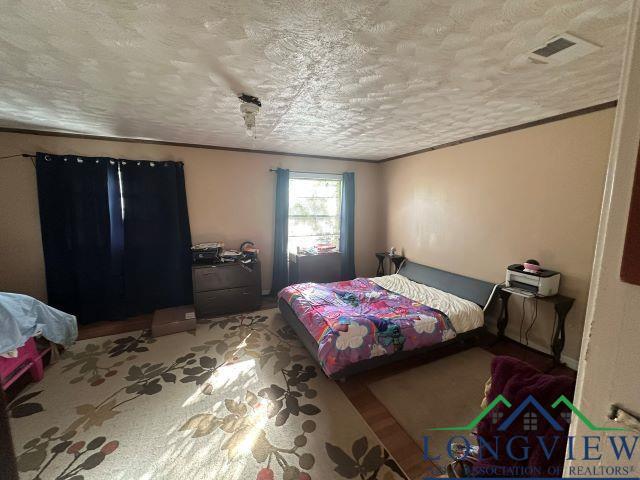729 Rosehill Rd, Timpson, TX 75975 - bedroom featuring a textured ceiling