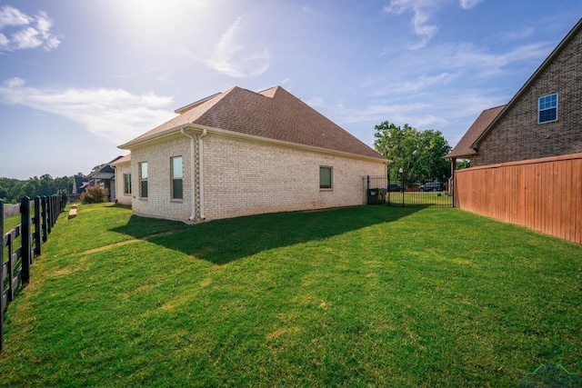 4523 Lone Oak Ln, Longview, TX 75605 - rear view of property featuring brick siding, a fenced backyard, and roof with shingles