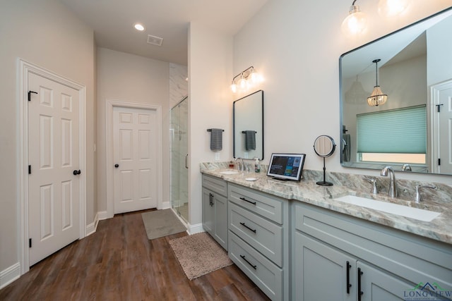 4523 Lone Oak Ln, Longview, TX 75605 - bathroom featuring double vanity, a stall shower, and wood finished floors