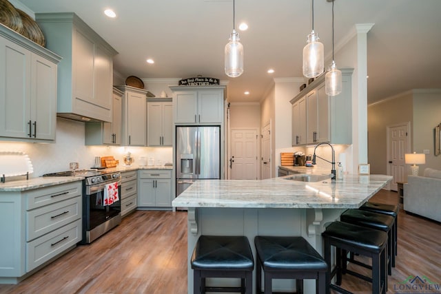 4523 Lone Oak Ln, Longview, TX 75605 - kitchen with appliances with stainless steel finishes, a peninsula, crown molding, light wood-style flooring, and light stone counters
