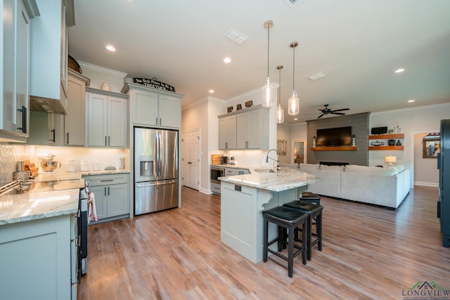 4523 Lone Oak Ln, Longview, TX 75605 - kitchen featuring stainless steel fridge, ornamental molding, electric range oven, a peninsula, and open floor plan
