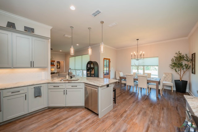 4523 Lone Oak Ln, Longview, TX 75605 - kitchen with stainless steel dishwasher, a peninsula, a chandelier, light wood finished floors, and ornamental molding