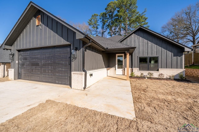 modern farmhouse style home with board and batten siding, concrete driveway, roof with shingles, and a garage