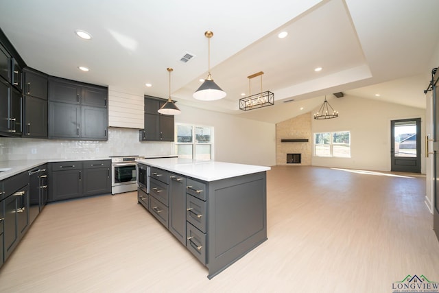 kitchen with light countertops, visible vents, vaulted ceiling, and stainless steel electric range