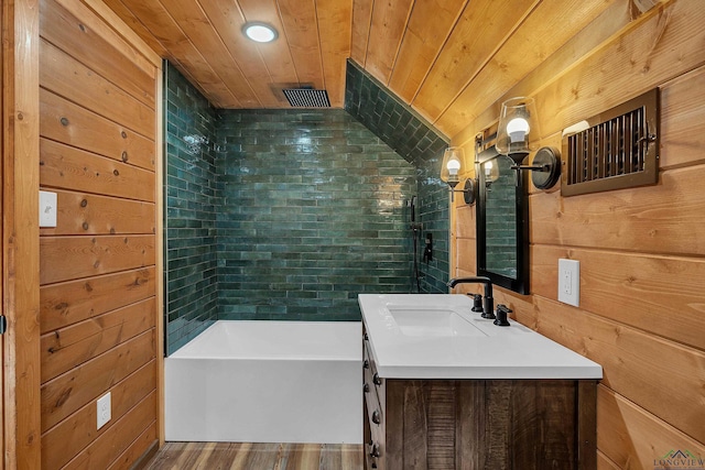 bathroom with a bathtub, vanity, wood walls, and wood ceiling