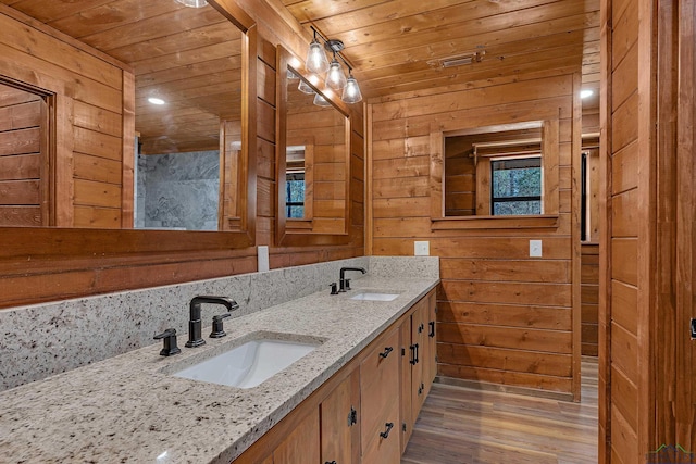 bathroom featuring hardwood / wood-style floors, vanity, wood ceiling, and wooden walls