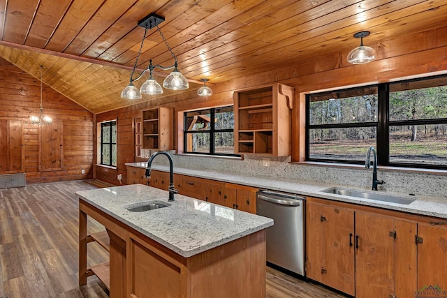 kitchen with decorative light fixtures, sink, and stainless steel dishwasher